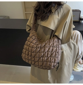 Brown quilted bubble shoulder bag shown on model for size and capacity detail