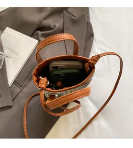 Top view of a straw bucket bag showing storage capacity for phone and lipstick inside