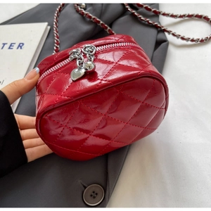 Detailed macro view of red quilted leather texture and silver heart charm pendant