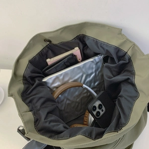 Spacious green canvas tote bag showing large capacity for laptop and daily essentials