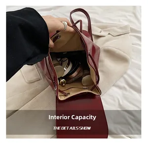 Detail shot of deep burgundy glossy backpack interior with cosmetics and drawstring closure