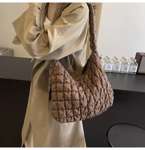 Detail of brown quilted bubble texture on lightweight nylon puffy shoulder bag