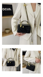 Detailed view of black velvet quilted vanity bag with golden flower logo and chain strap