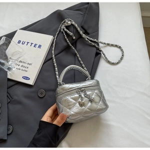 Detail of silver quilted mini box bag with heart zippers and metal chain strap
