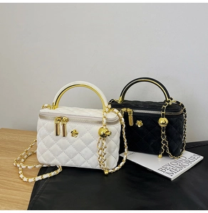 Close-up of quilted diamond pattern and metallic handle on stylish leather box bags