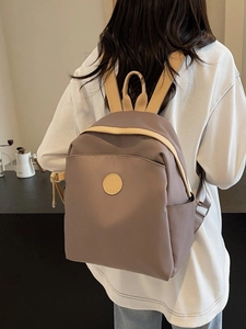 Fashionable taupe nylon commuter backpack for women with beige straps in a lifestyle view