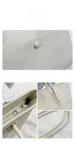 Detail view of cream white lychee texture leather tote with metallic zipper and stitching