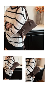 Detail of vintage dark brown suede underarm bag with baseball glove pendant and zipper