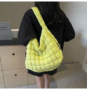 Model wearing vibrant neon green quilted bubble tote bag featuring puffed square texture