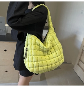 Close-up of vibrant neon green quilted bubble bag with textured puffed fabric detail