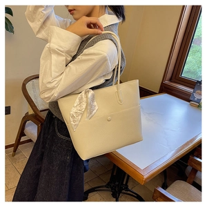 Chic beige tote bag in lychee pattern leather with floral scarf and double handles