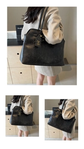 Detailed shot of a vintage black tote bag featuring a leather-like texture and a hanging tag