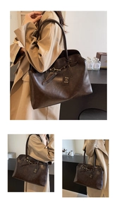 Detail view of deep coffee vintage tote bag with elegant shoulder strap and metallic buckle