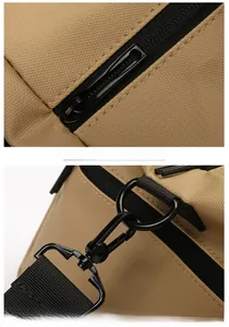 Detail of durable black metal hardware and smooth zipper on khaki fitness bag