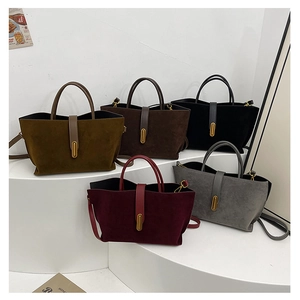 Detailed view of matte texture tote bags in five colors with metallic gold cylinder locks