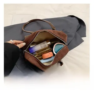 Interior view of vintage brown suede bowling bag showing large capacity and zipper detail
