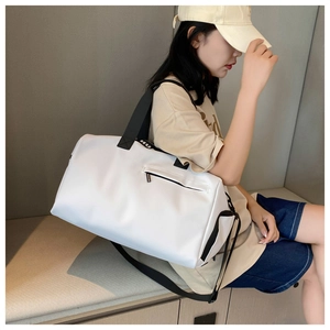 Lifestyle view of a white waterproof fitness bag with spacious capacity and black straps