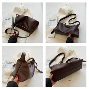 Détails du grand sac cabas en cuir marron foncé avec ferrures dorées et bandoulière