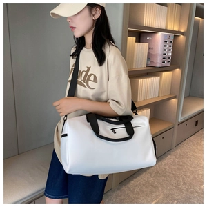 White fitness bag with dry-wet separation and adjustable straps shown in indoor setting
