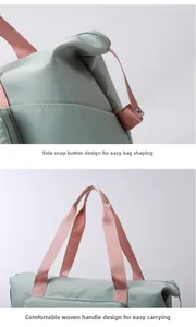 Detail view of the green oxford travel bag showing side snap buttons and woven handles