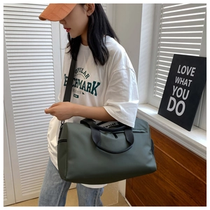 Olive green travel gym bag shown with adjustable shoulder strap and large capacity