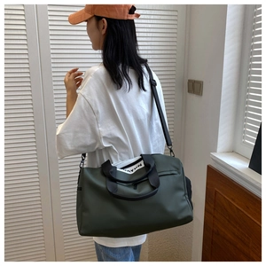 Detail of dark green fitness bag with large capacity and waterproof fabric material