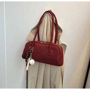 Detail of burgundy suede shoulder bag with MUHETI SHI SHANG embossing and baseball charm