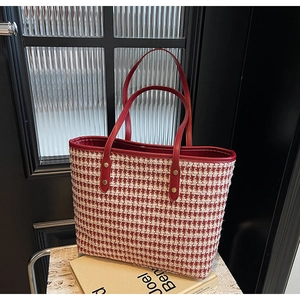 Detail of red houndstooth tote with premium leather handles and gold metal rivets