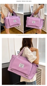 Detailed view of the purple Oxford cloth travel bag featuring the front zipper pocket