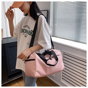 Pink fitness bag with dry-wet separation showing waterproof nylon fabric and shoulder strap