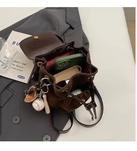 Deep brown leather backpack with spacious interior showing phone and wallet storage