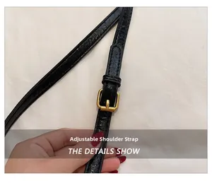 Detail of black leather shoulder strap with adjustable gold buckle for boston bag