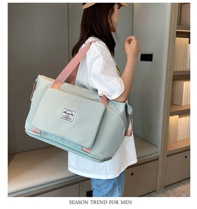 Detail view of the large Oxford cloth travel bag with light green and pink contrast straps