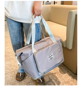 Macro detail of grey Oxford cloth travel bag showing durable handles and Hong Fu logo