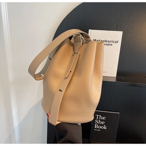 Close-up of litchi grain leather bucket bag with adjustable wide shoulder strap in khaki