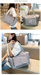 Detailed views of grey waterproof oxford travel bag showing handles and shoulder straps