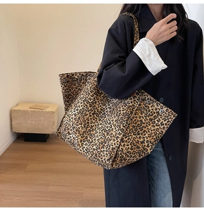 Primer plano del bolso tote de leopardo con hebillas metálicas vintage en lona gruesa