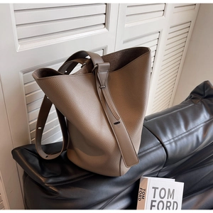 Detail of premium lychee grain leather bucket bag with adjustable strap in tan brown