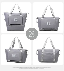 Detail view of light grey Oxford travel bag showing the expandable bottom and wide straps