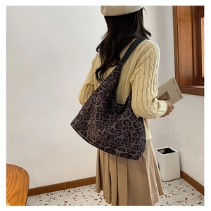 Detailed view of leopard print tote bag in soft fabric featuring a large hobo silhouette