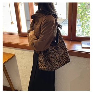 Chic leopard print tote bag styled with a winter coat in a natural lifestyle setting
