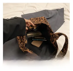 Interior view showing large capacity of leopard print bucket bag with magnetic closure