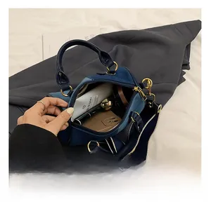 Detail view of the blue color-block pillow bag interior showing daily storage capacity