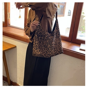 Close-up of leopard print tote bag with soft texture in a stylish lifestyle setting