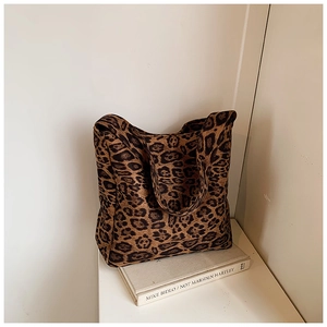 Close-up detail of leopard print tote bag showing thick canvas texture and patterns