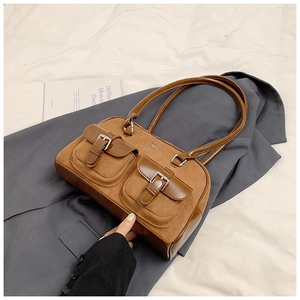 Detail view of brown vintage bowling bag with dual pockets and metal buckle accents