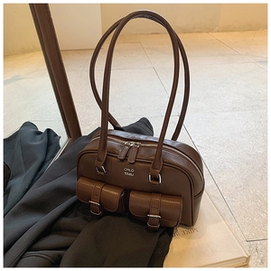 Detail view of vintage brown bowling bag with double front flap pockets and zip closure