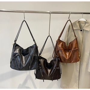 Three vintage leather tote bags in black, dark coffee and caramel with bow details