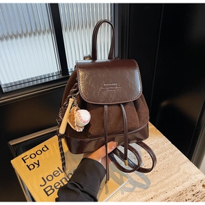 Close-up of vintage brown leather backpack with premium texture and stitching details