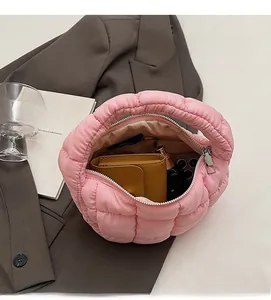 Detailed interior of the pink puffer tote showing spacious capacity for a wallet and phone